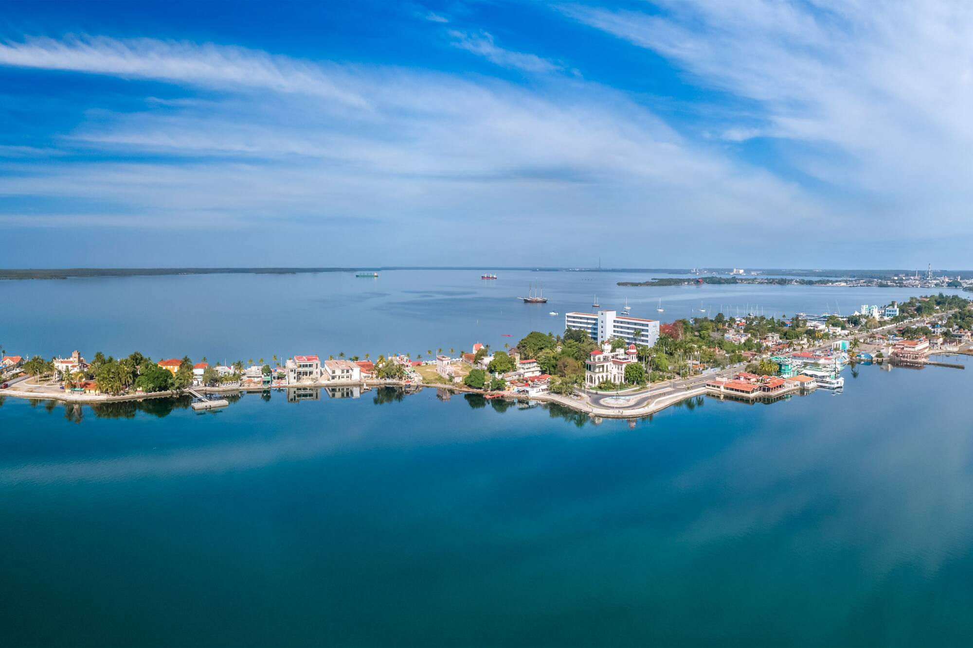 a body of water with buildings and boats in the background