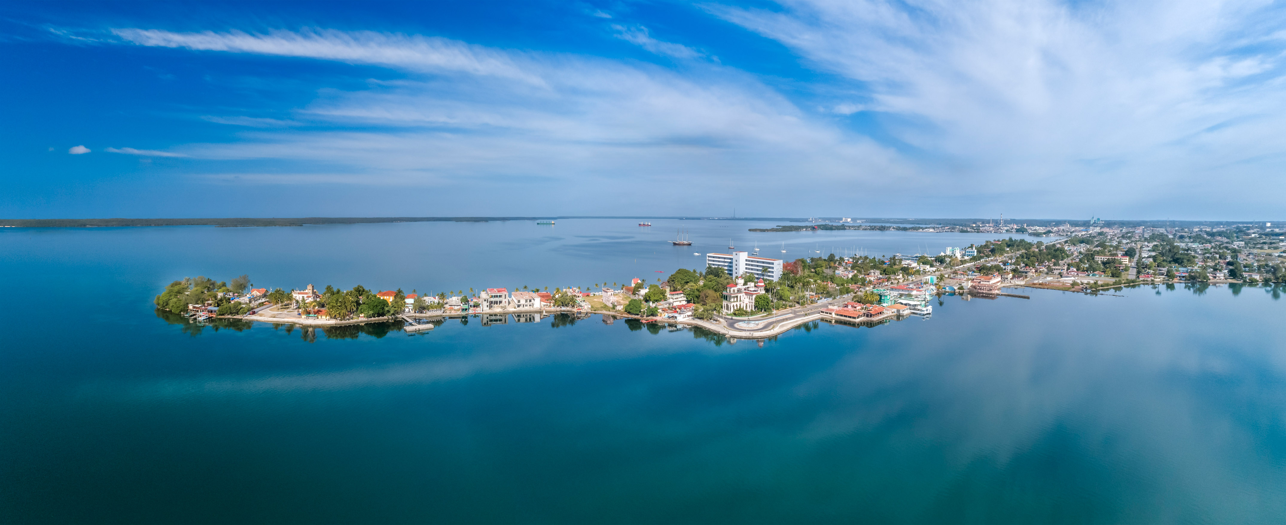 a body of water with buildings and boats in the background