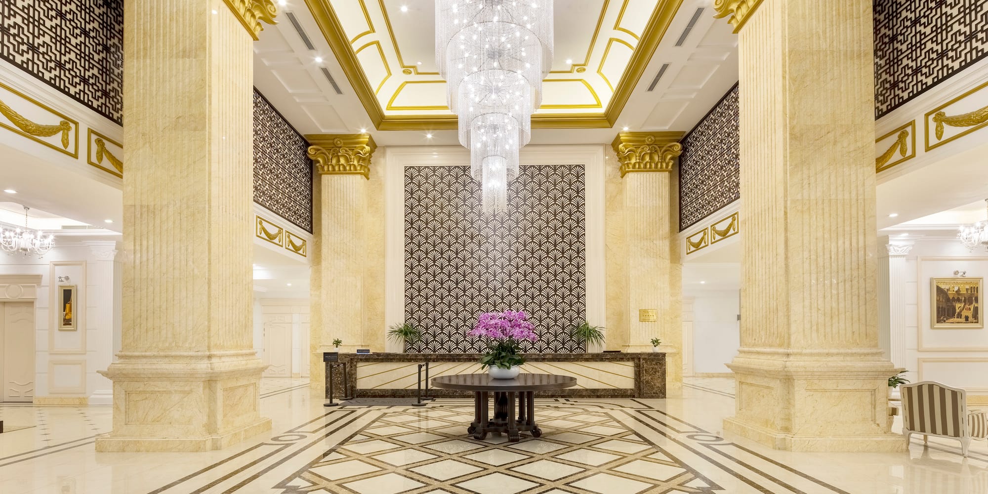 a large room with a table and chandeliers