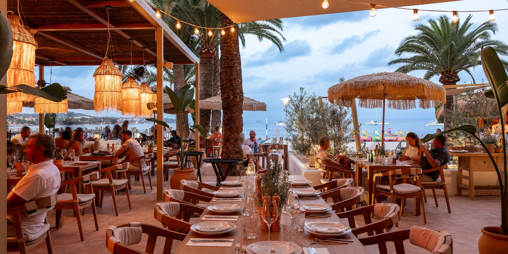 a restaurant with tables and chairs and umbrellas