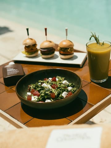 a plate of salad and burgers on a table