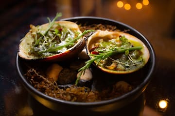 a bowl of food with a couple of shells
