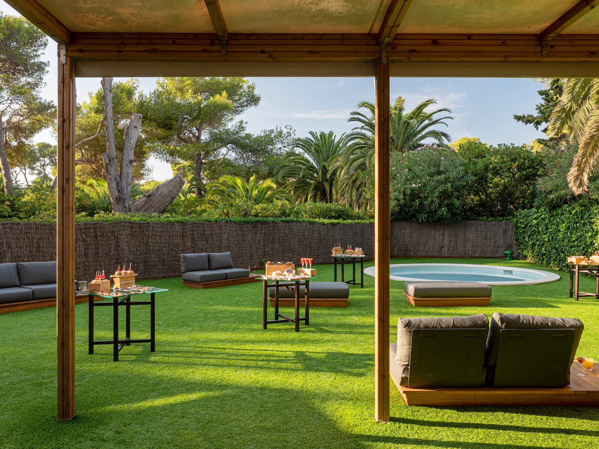a patio with a pool and tables