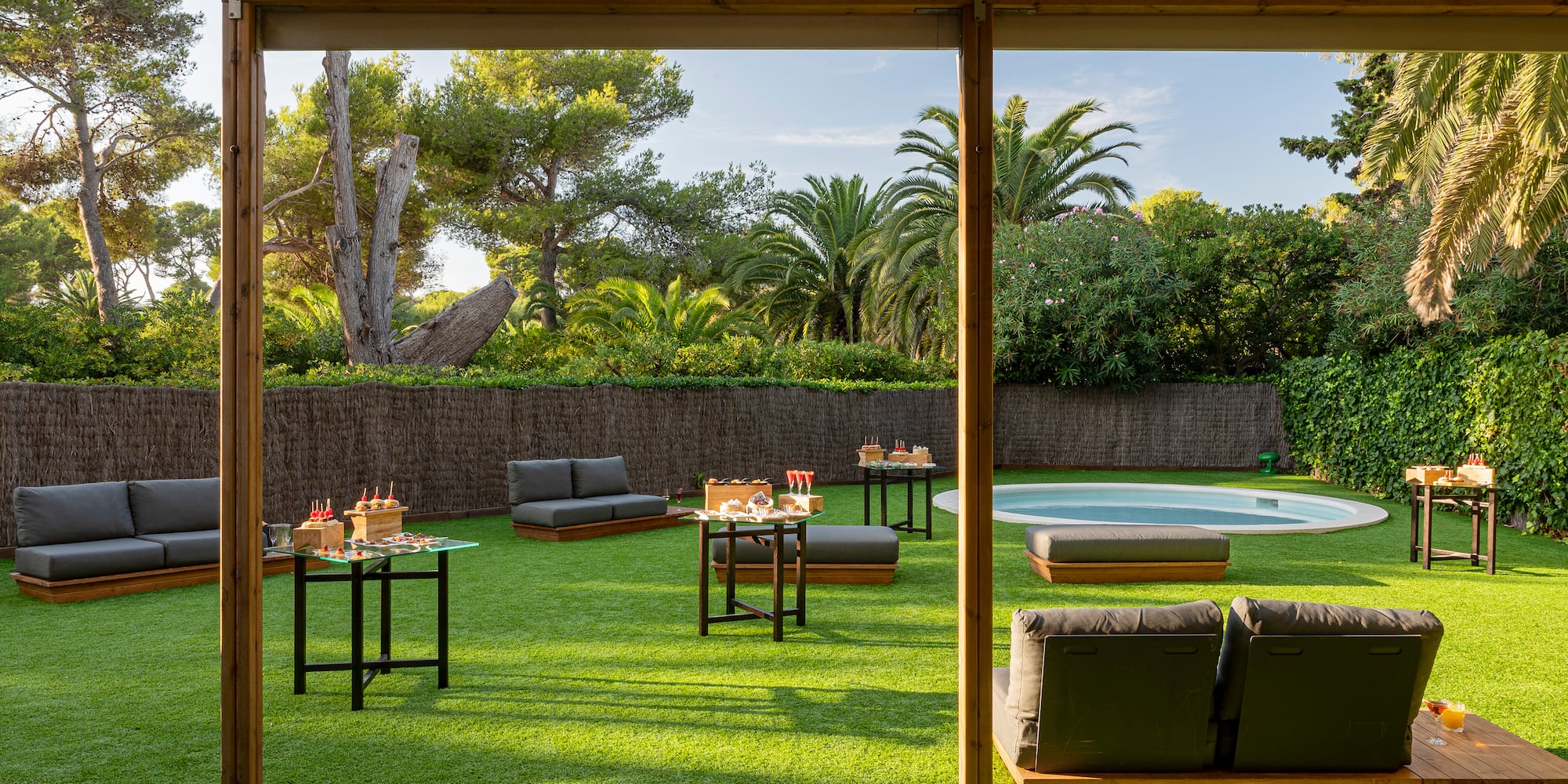 a patio with a pool and tables