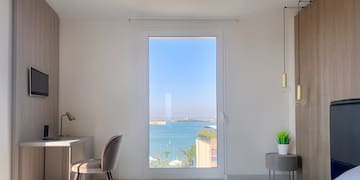 a room with a large window overlooking the water