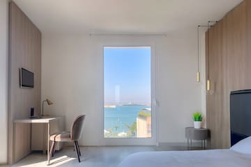 a room with a large window overlooking the water