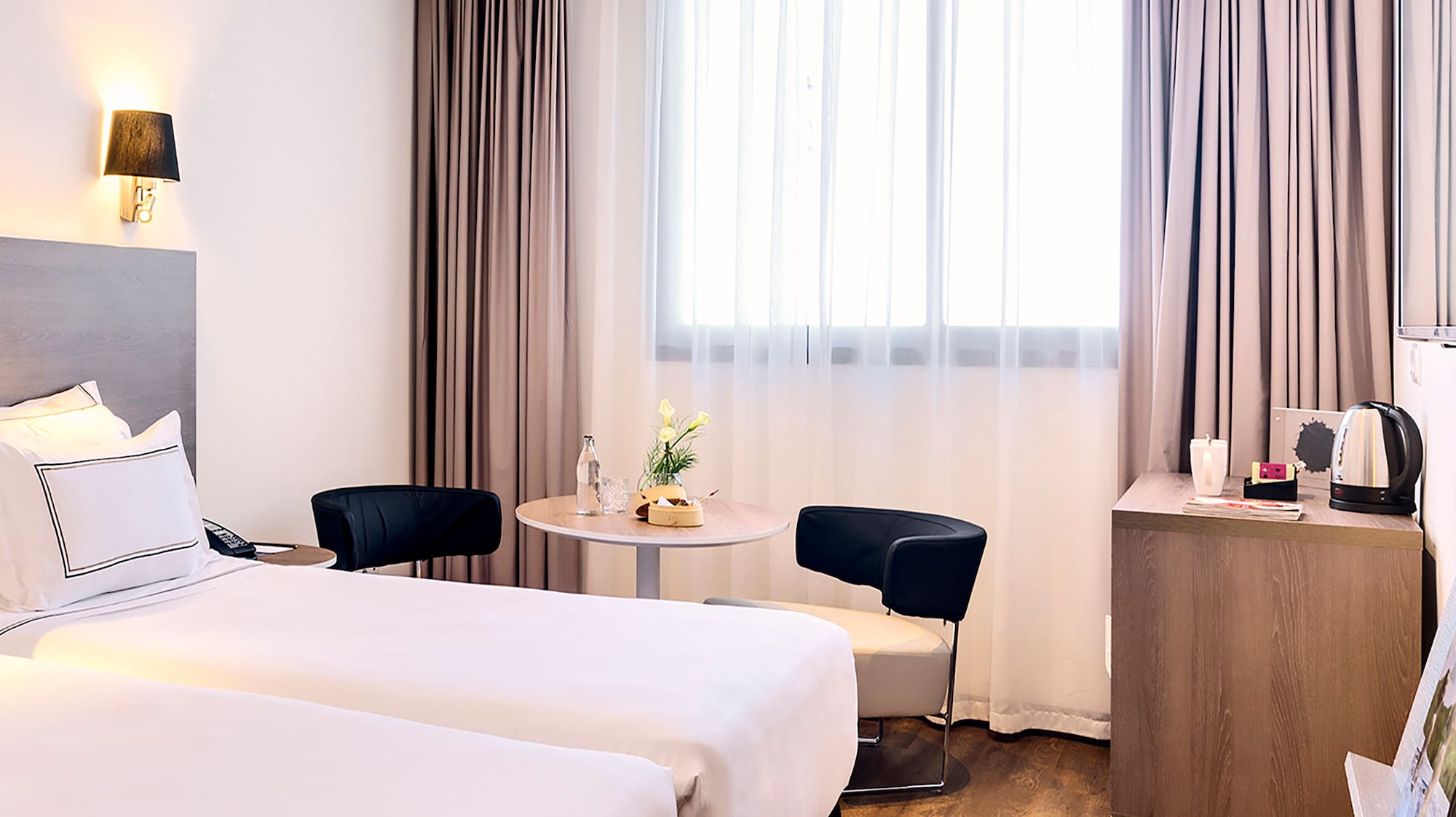 a room with two beds and a table