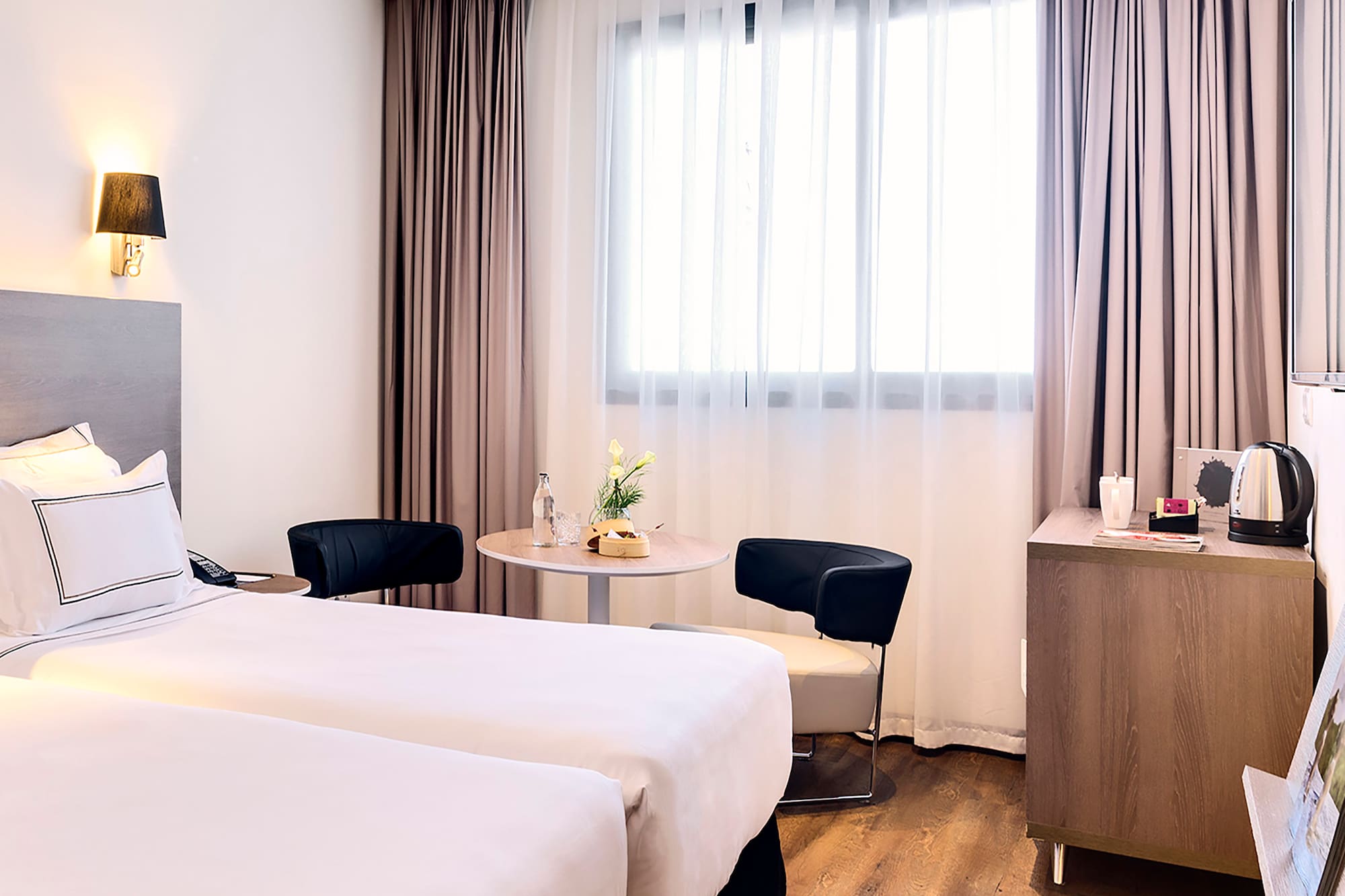 a room with two beds and a table