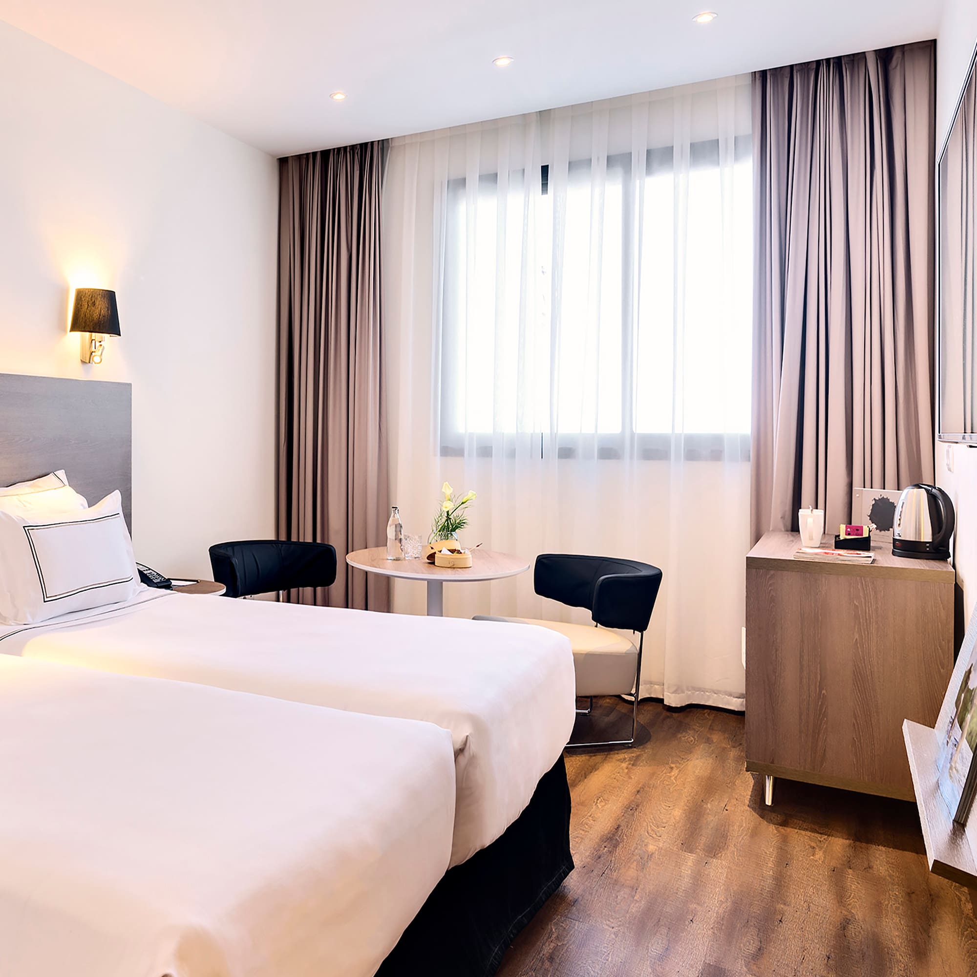 a room with two beds and a table