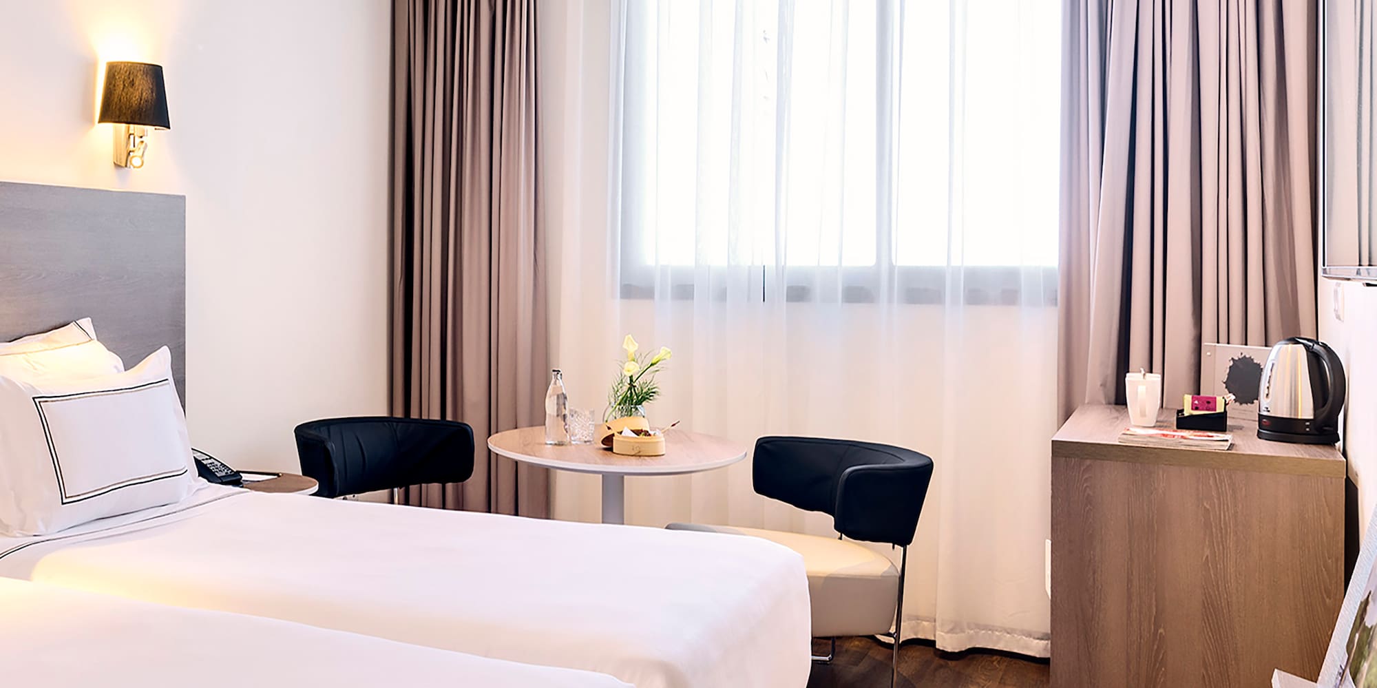 a room with two beds and a table