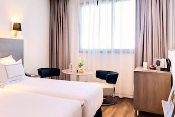 a room with two beds and a table