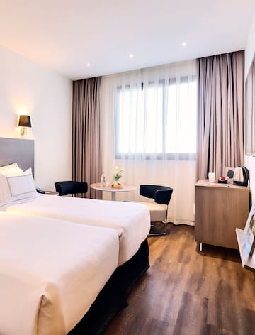 a room with two beds and a table