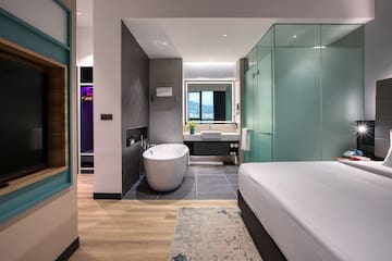 a room with a bed and bathtub