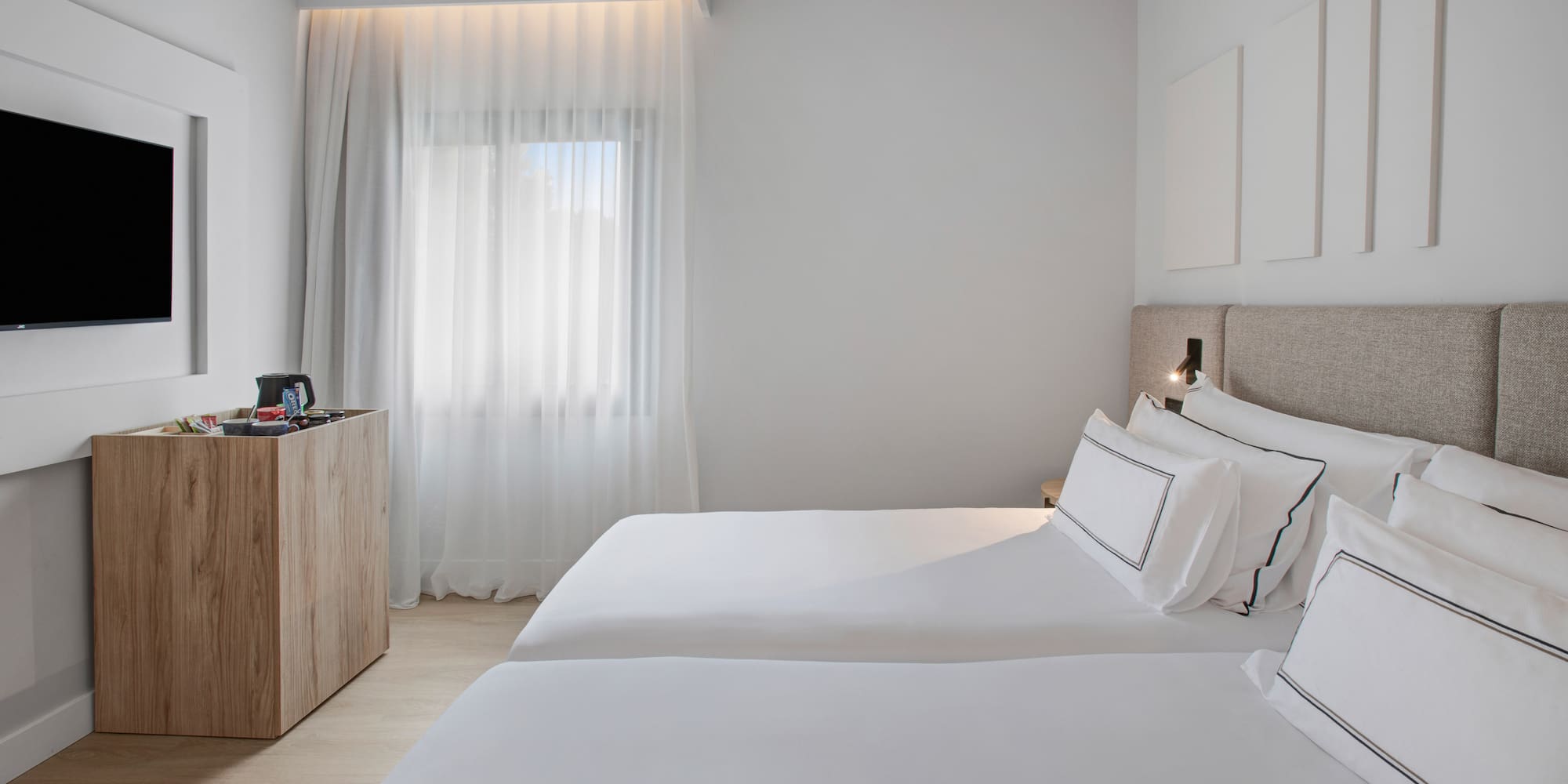 a room with two beds and a dresser