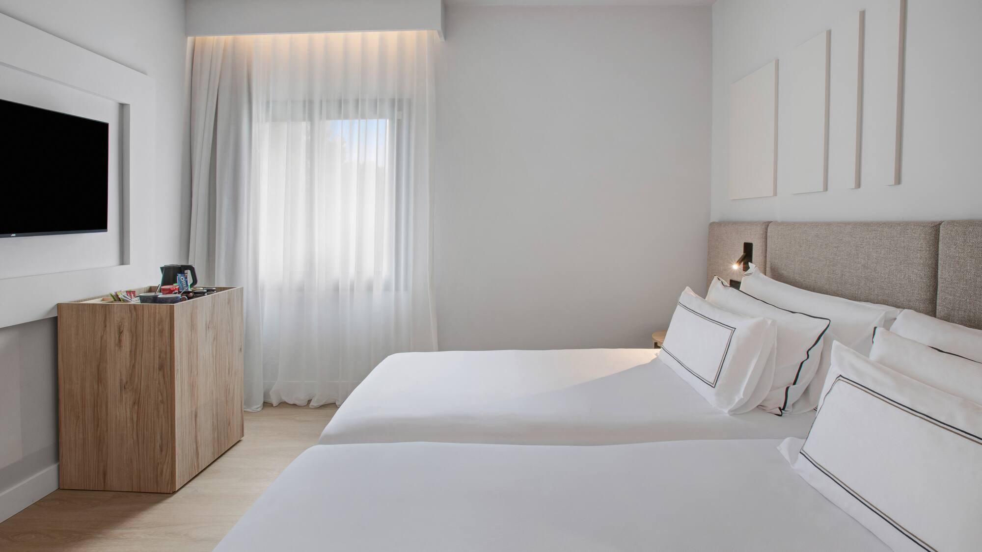 a room with two beds and a dresser