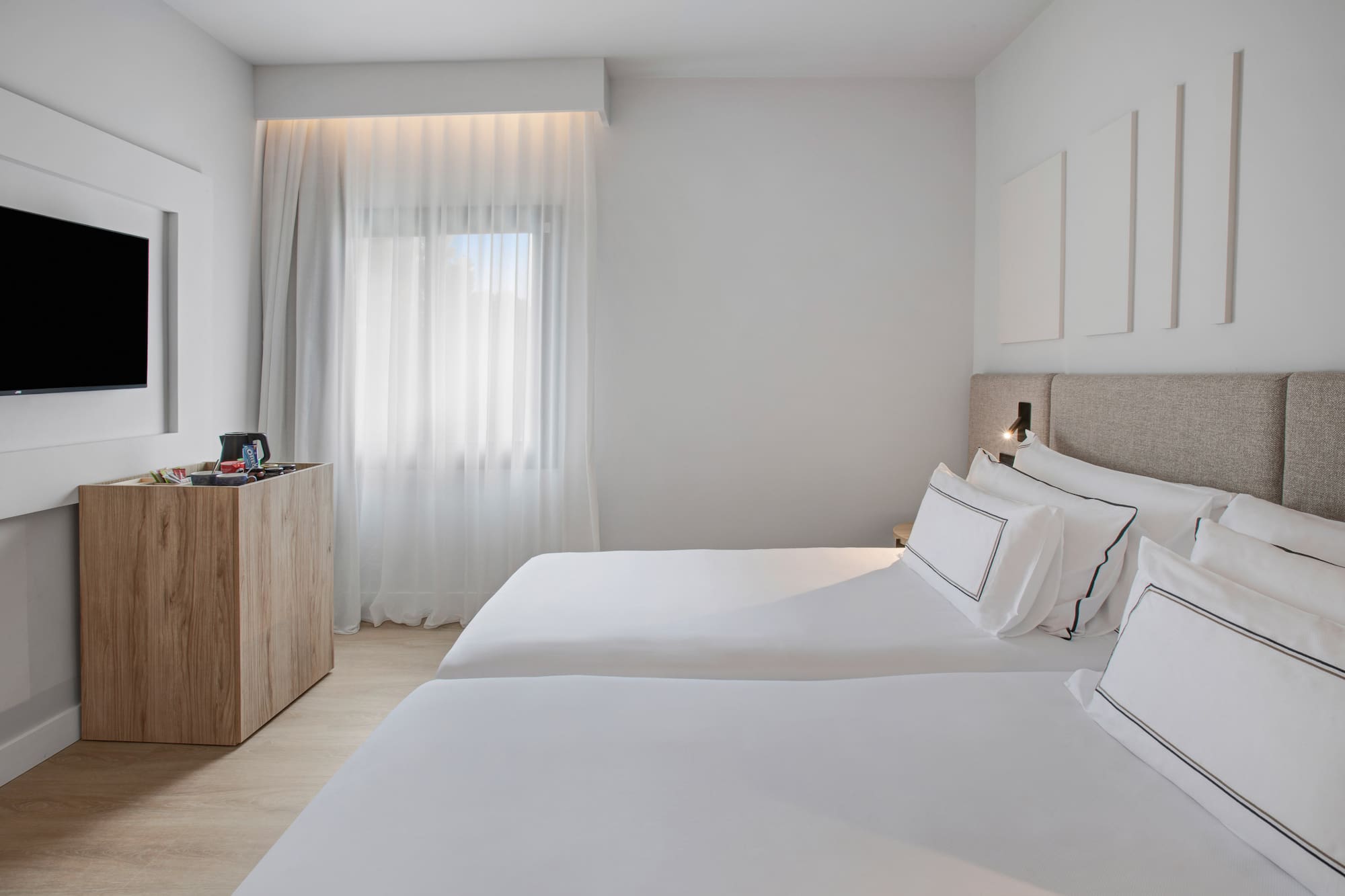 a room with two beds and a dresser