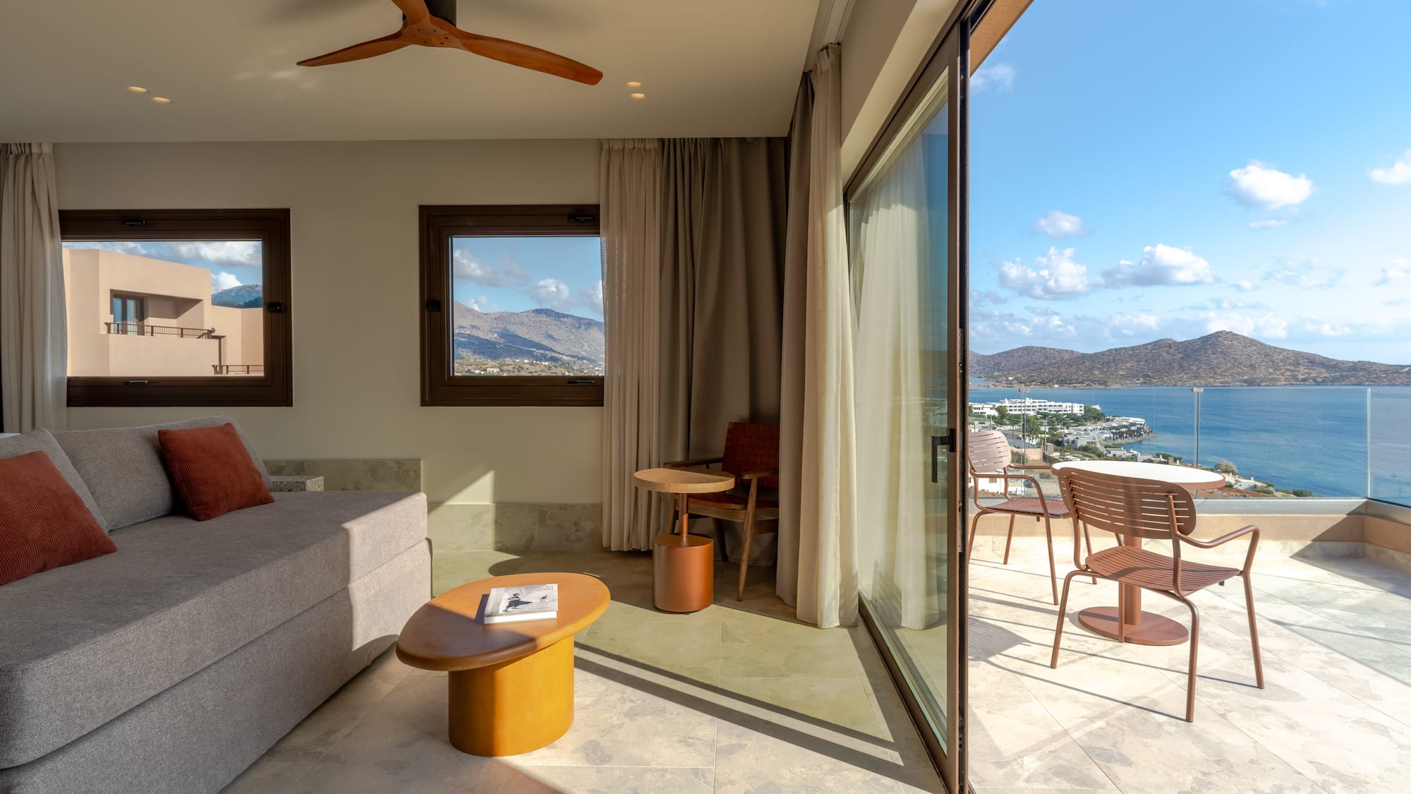 a living room with a view of the water and a couch
