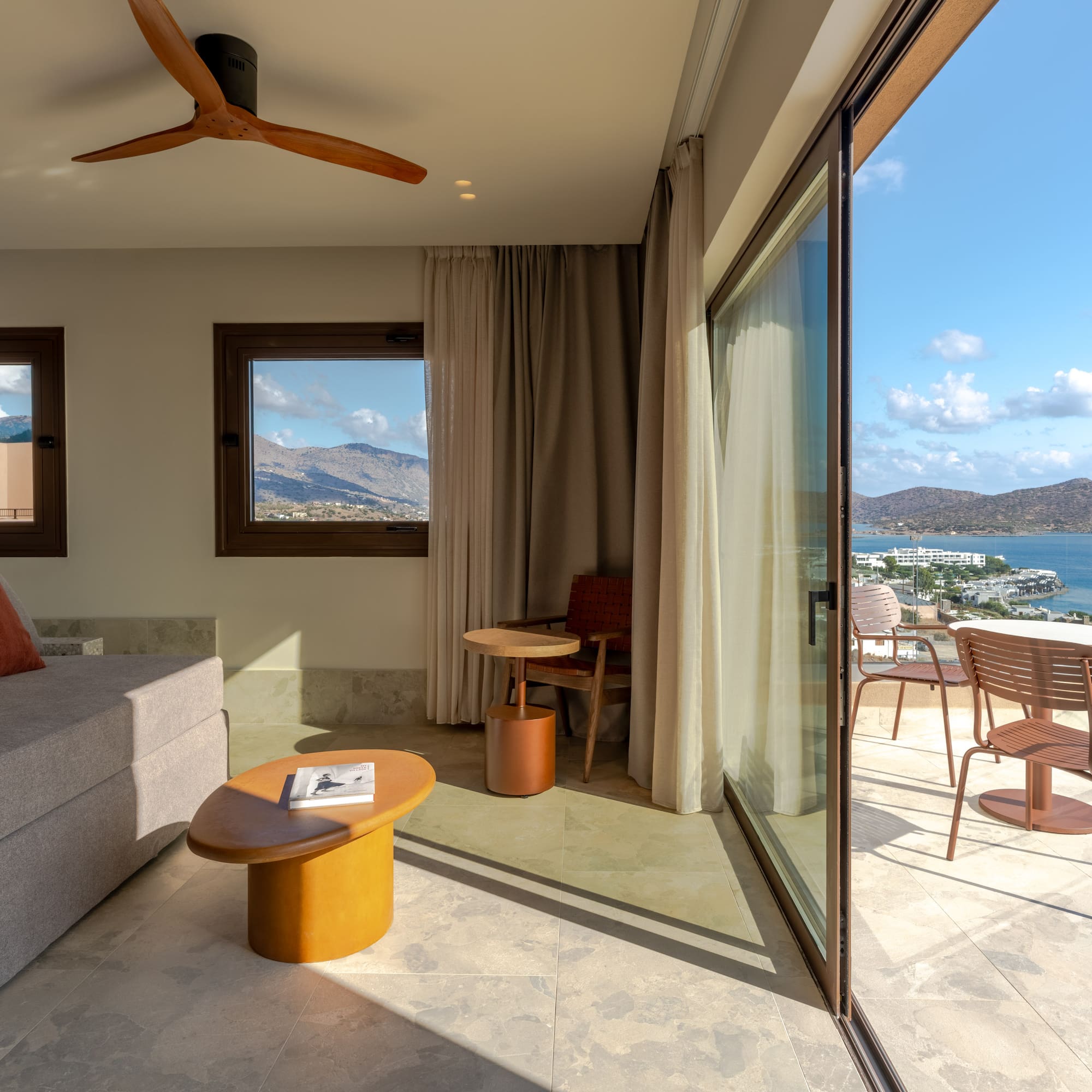 a living room with a view of the water and a couch
