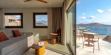 a living room with a view of the water and a couch