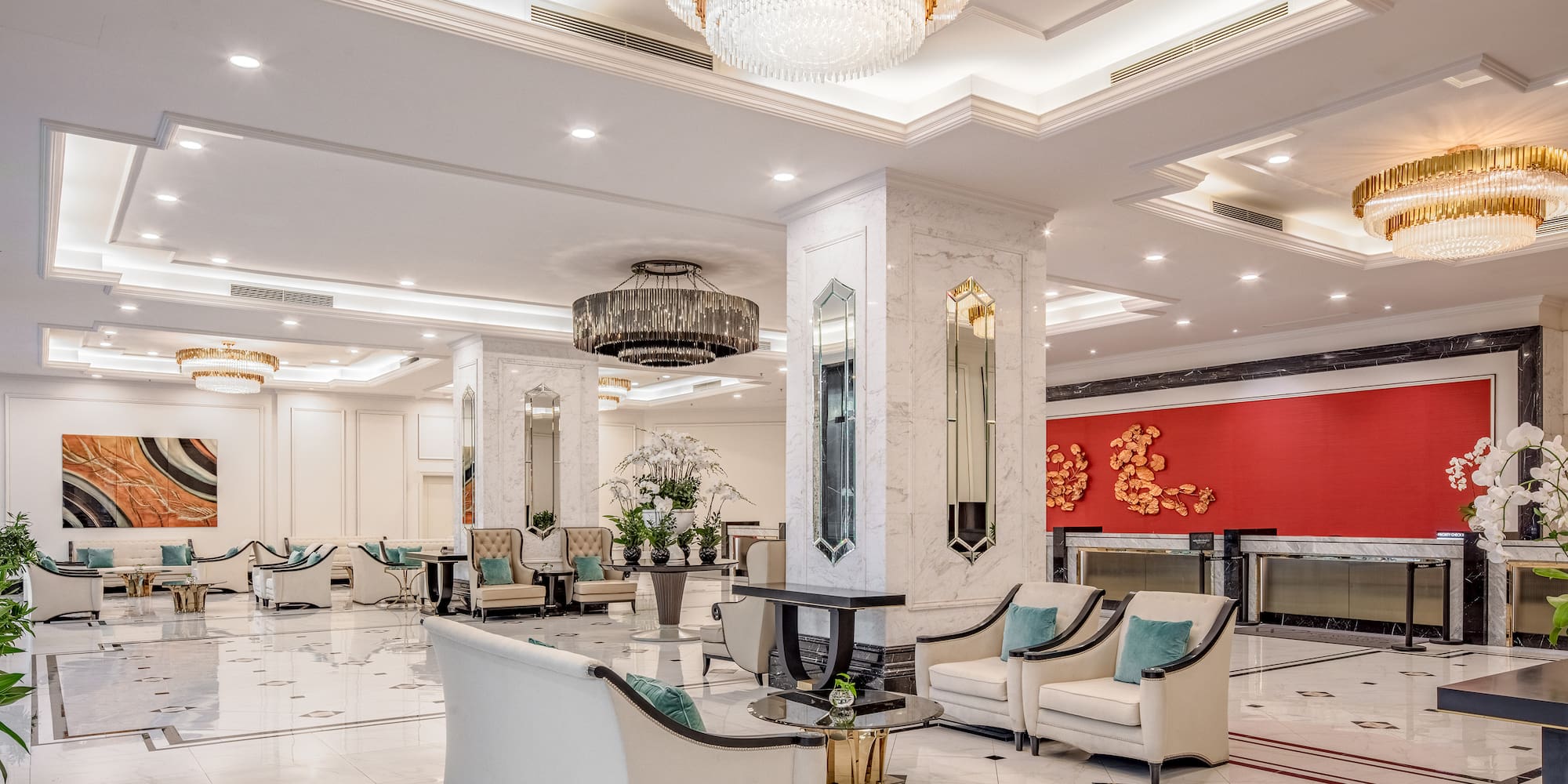 a large lobby with a chandelier and chairs