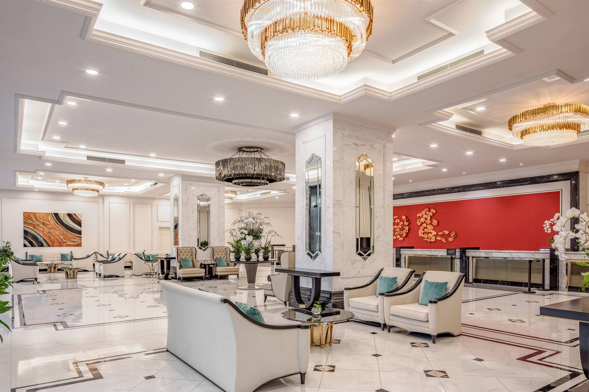 a large lobby with a chandelier and chairs