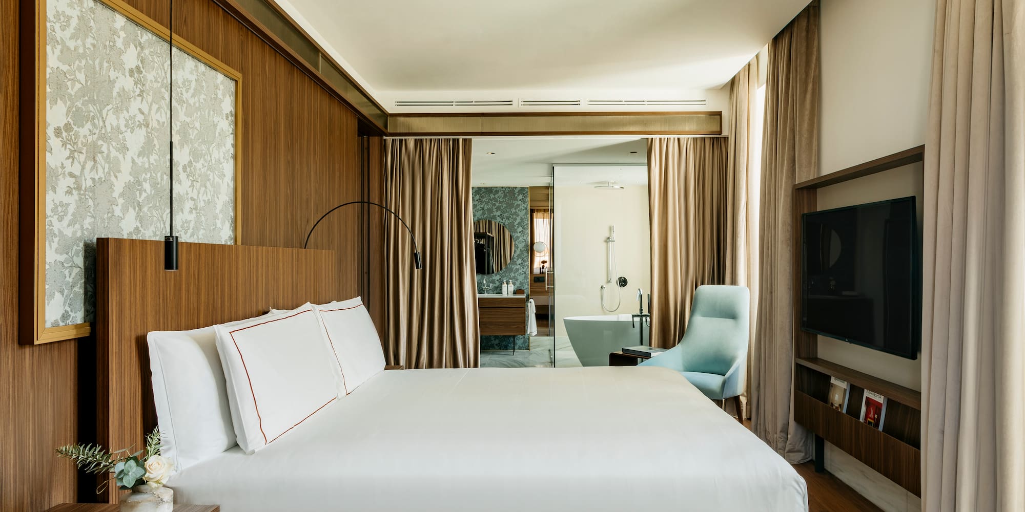 a room with a bed and a television