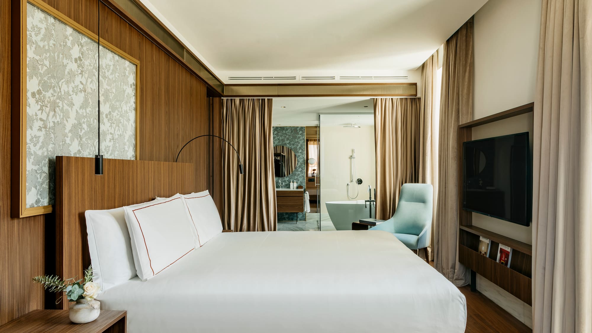 a room with a bed and a television