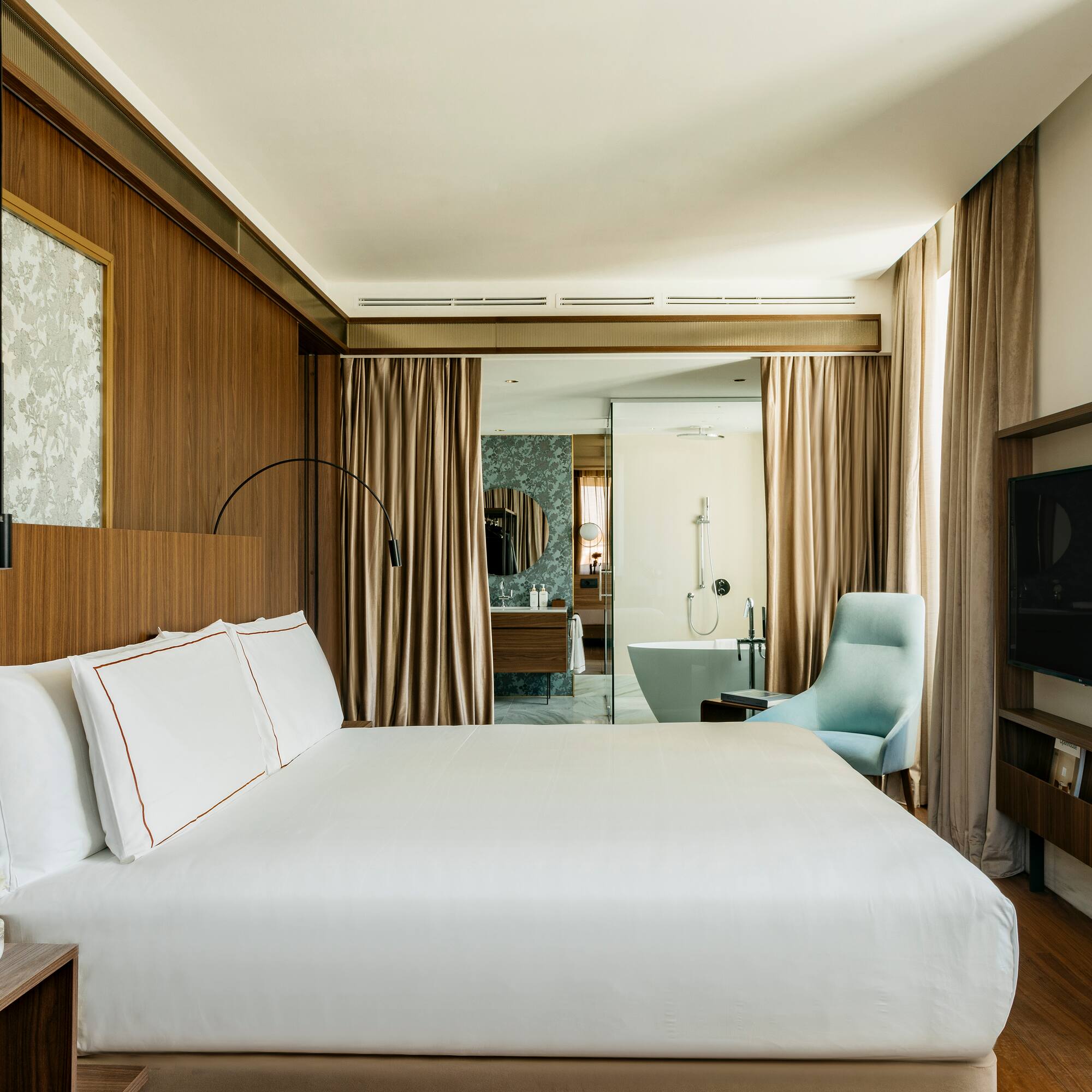 a room with a bed and a television