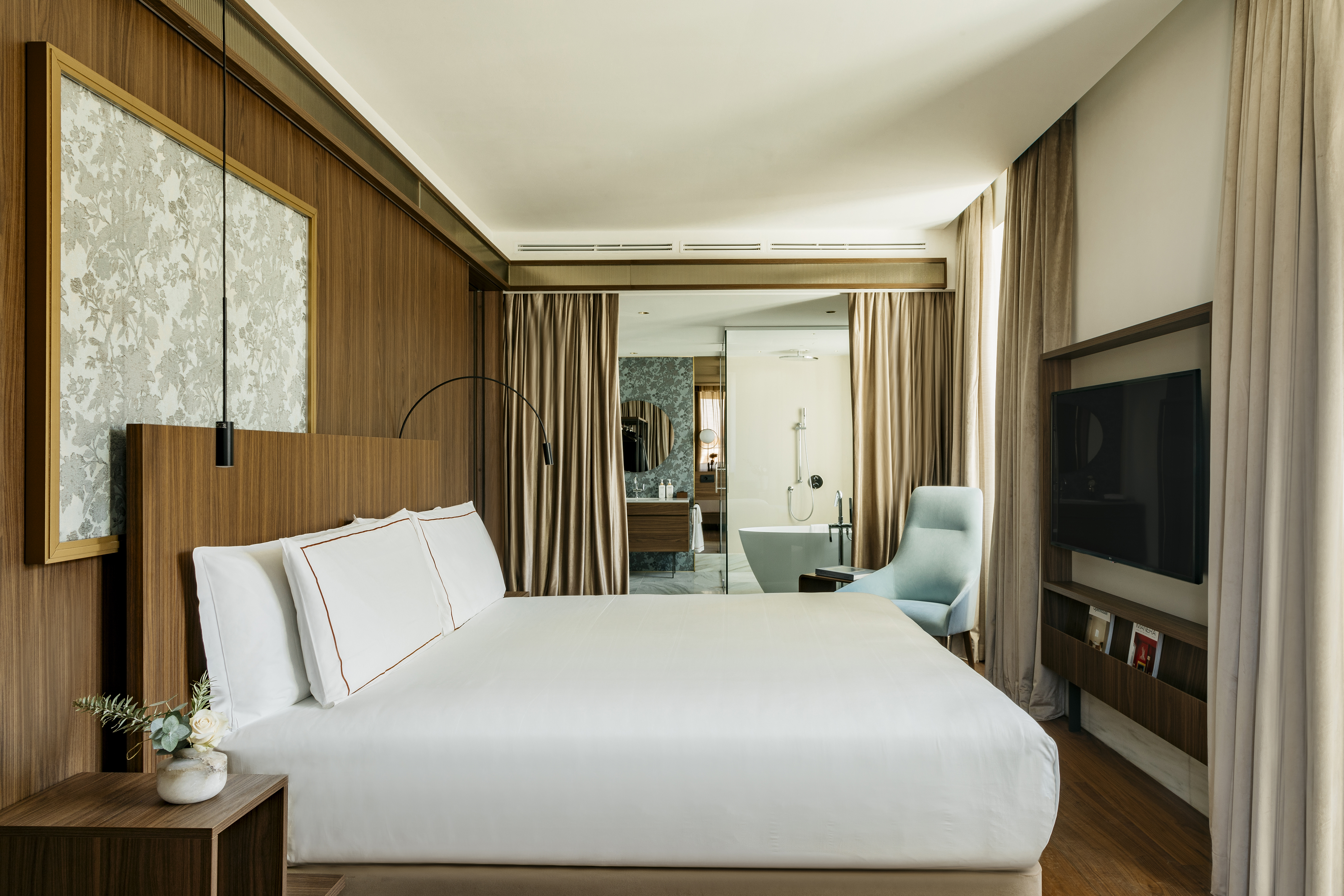 a room with a bed and a television