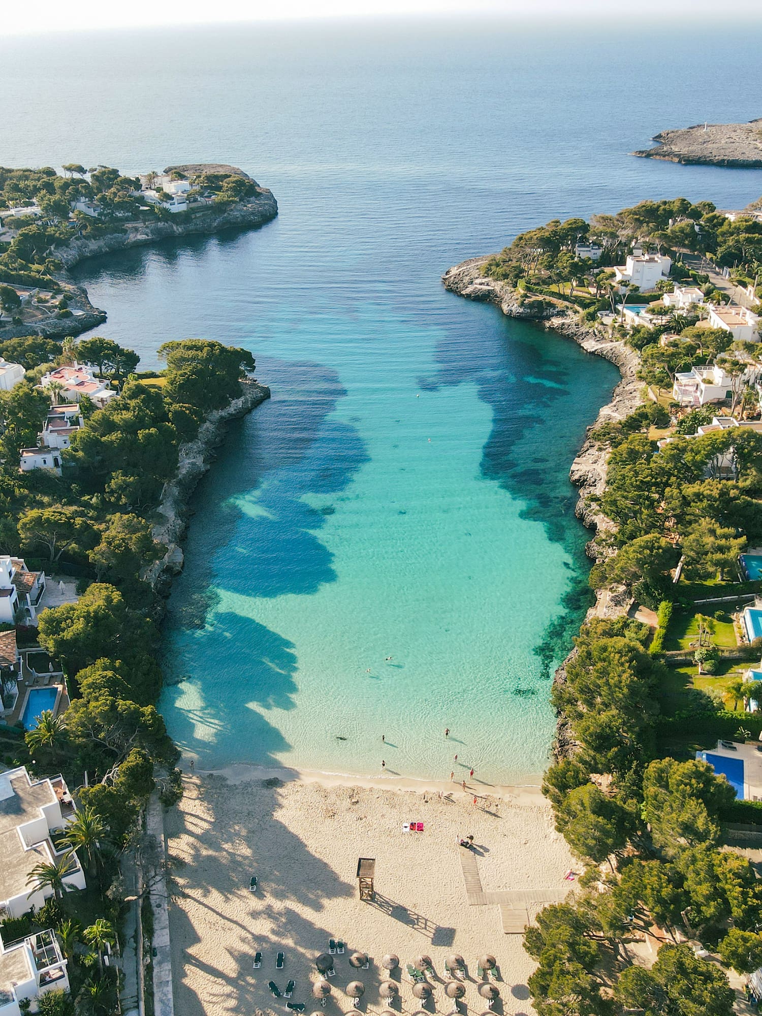 a beach with buildings and a body of water