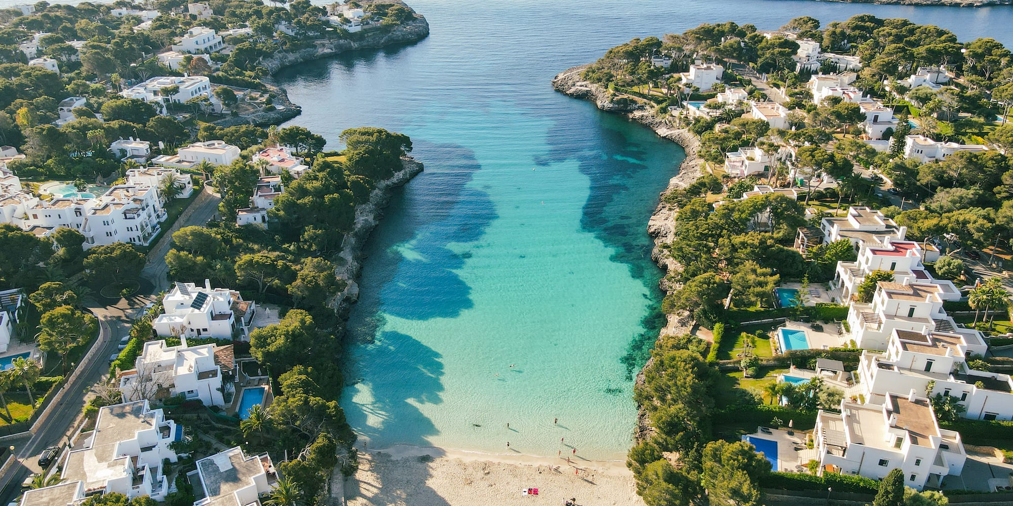 a beach with buildings and a body of water