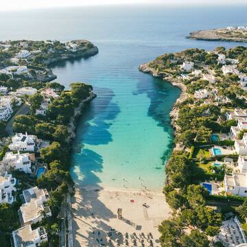 a beach with buildings and a body of water