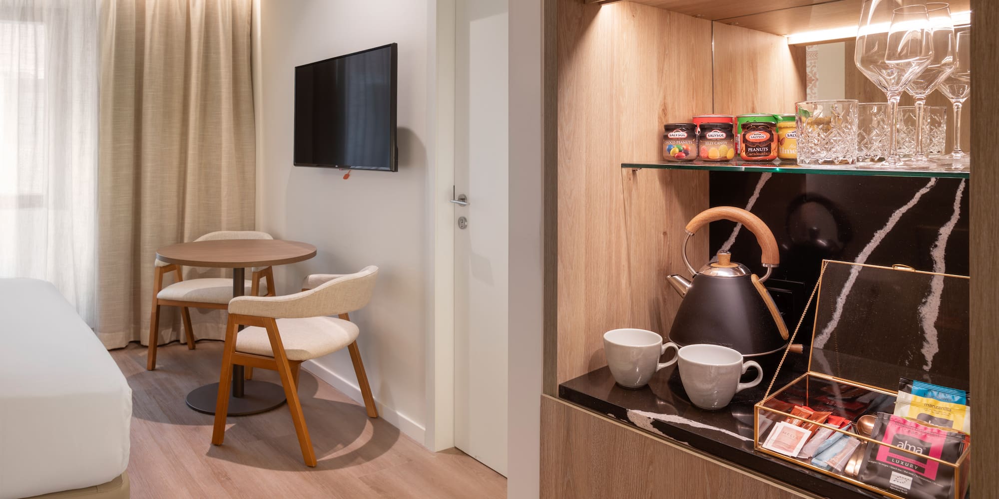 a room with a tv and a table and chairs