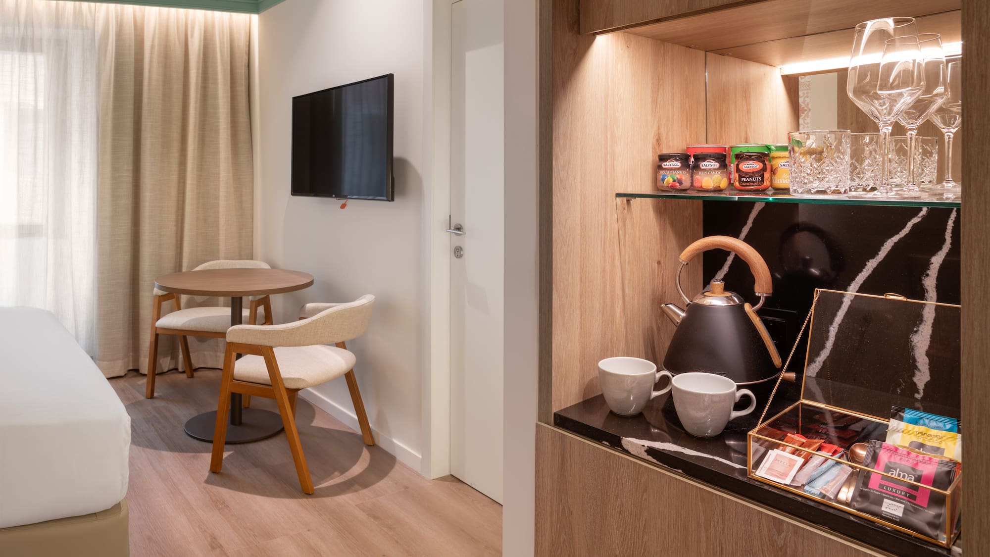 a room with a tv and a table and chairs