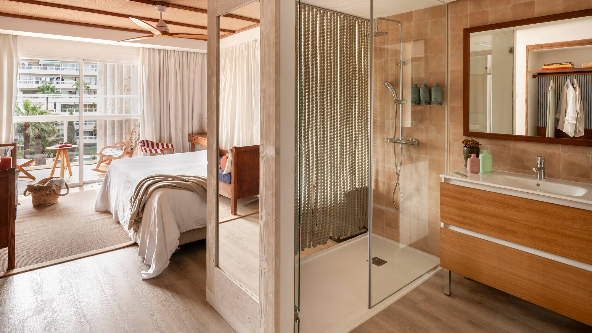 a bathroom with a bed and a shower