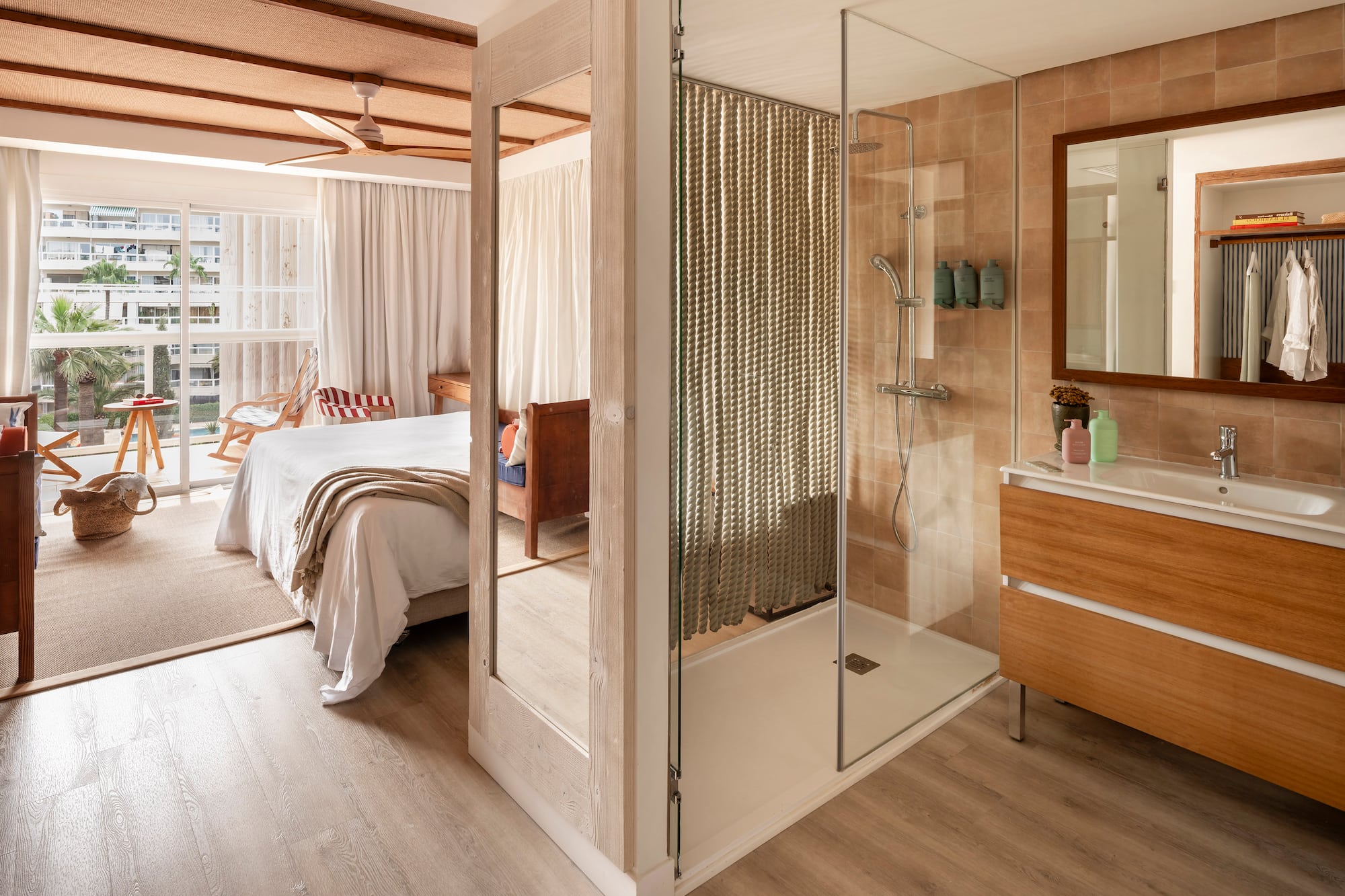 a bathroom with a bed and a shower