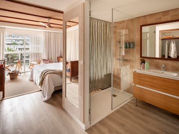 a bathroom with a bed and a shower