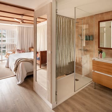 a bathroom with a bed and a shower