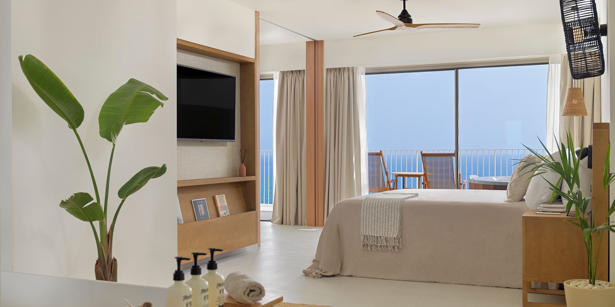 a bedroom with a television and a bed