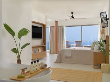a bedroom with a television and a bed