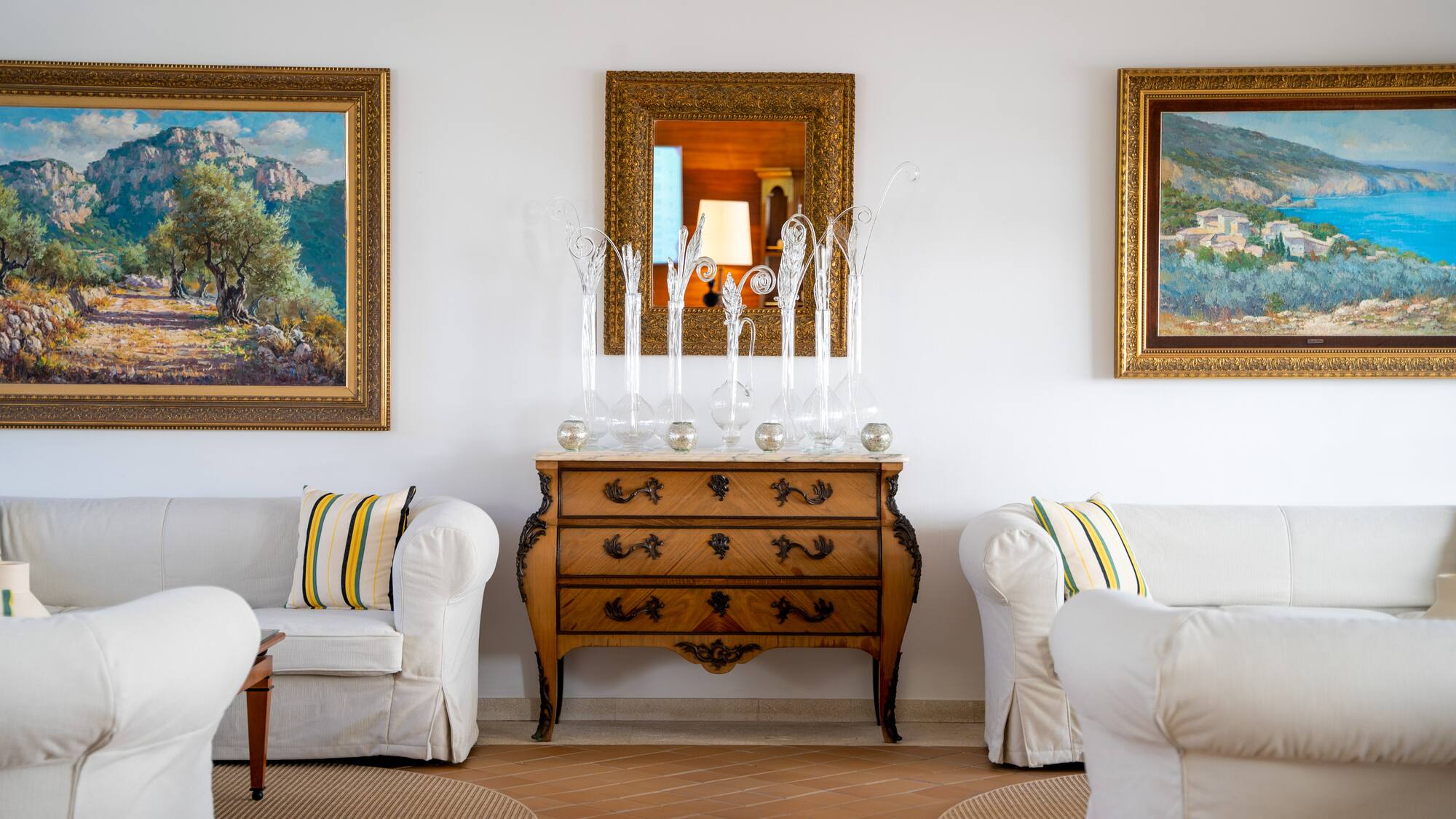 a room with white couches and a dresser