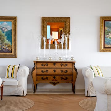 a room with white couches and a dresser