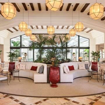 a room with a large round table and chairs