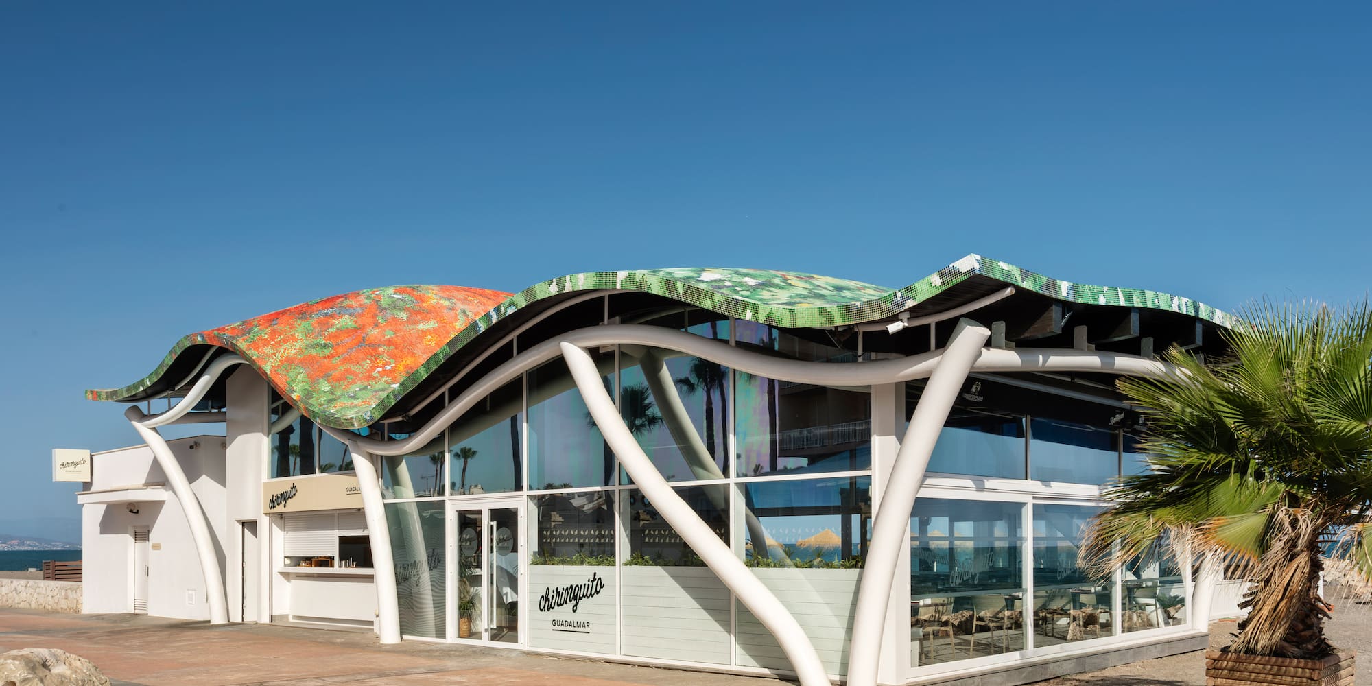 Chiringuito Guadalmar beach restaurant with unique wavy, colorful mosaic roof.