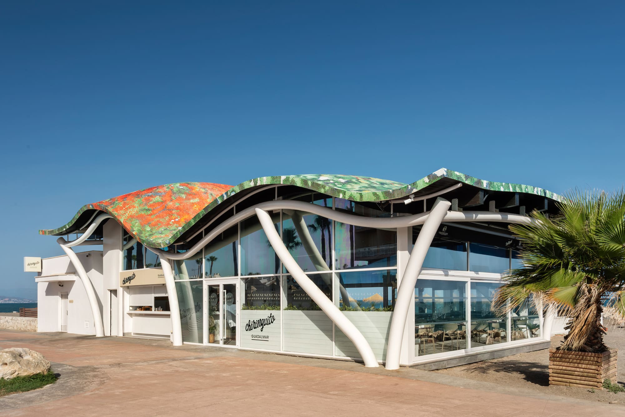 Chiringuito Guadalmar beach restaurant with unique wavy, colorful mosaic roof.