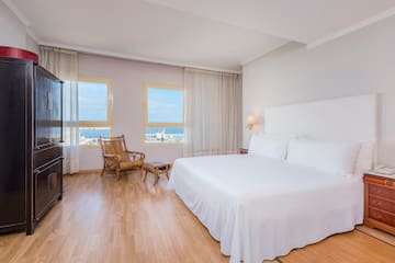 a bedroom with a bed and a chair