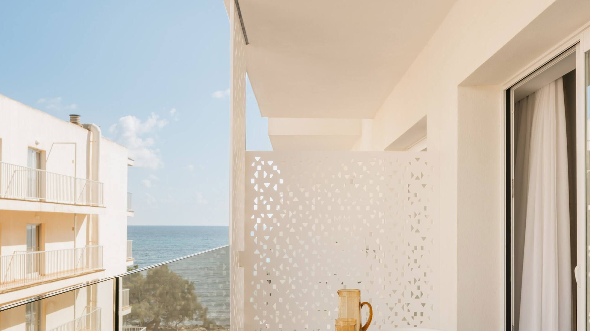 a balcony with a table and chairs