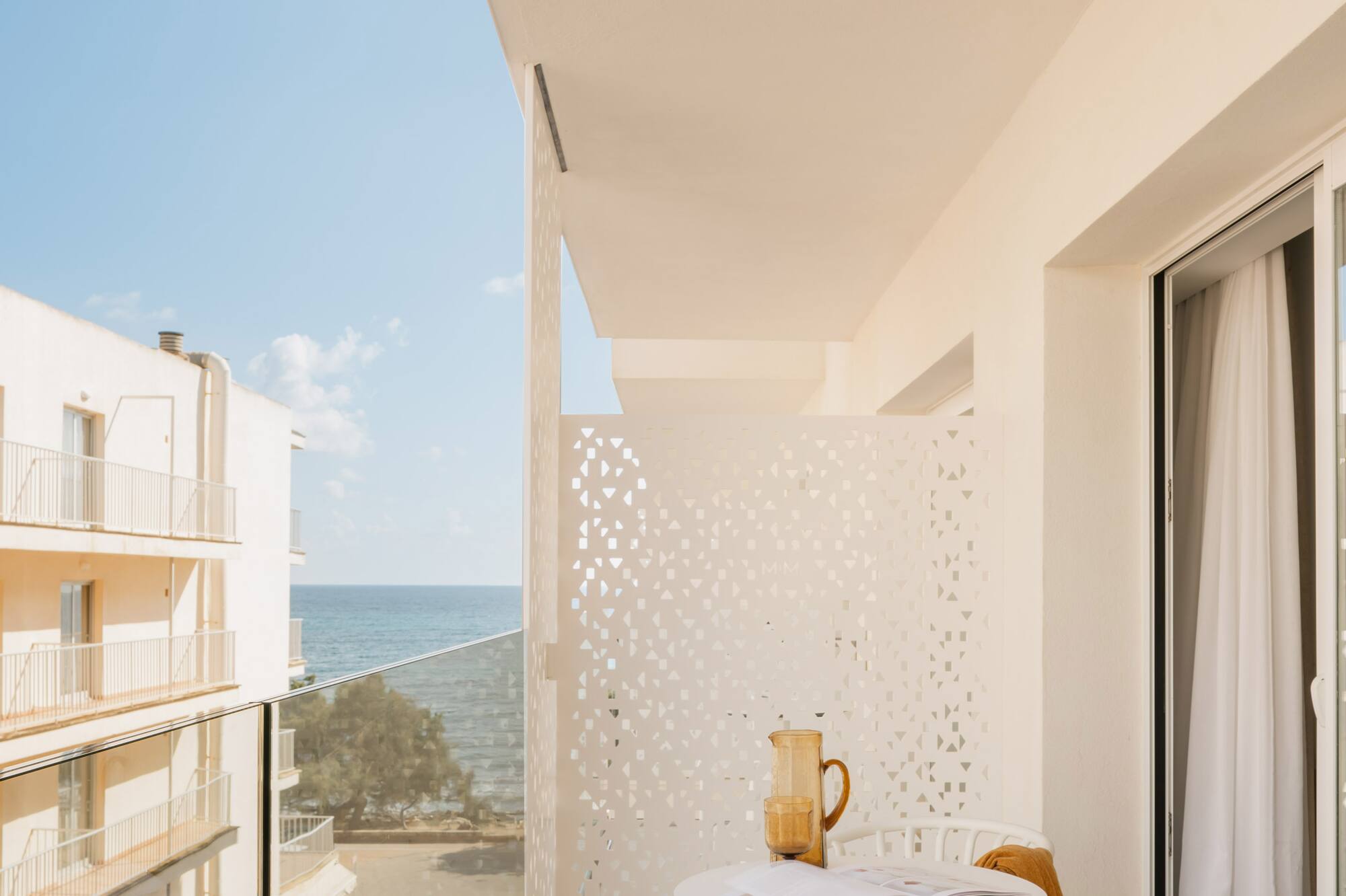 a balcony with a table and chairs