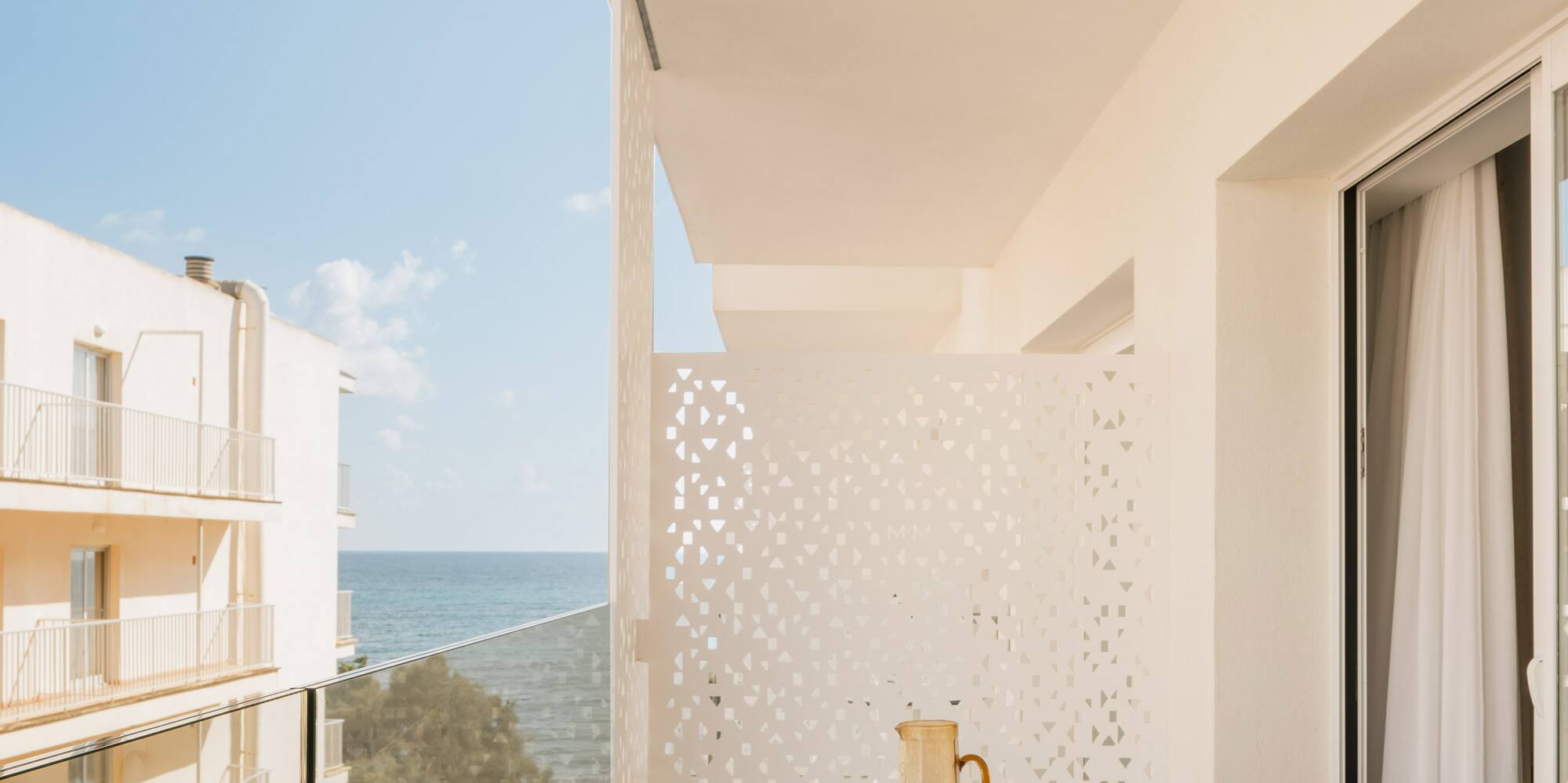 a balcony with a table and chairs