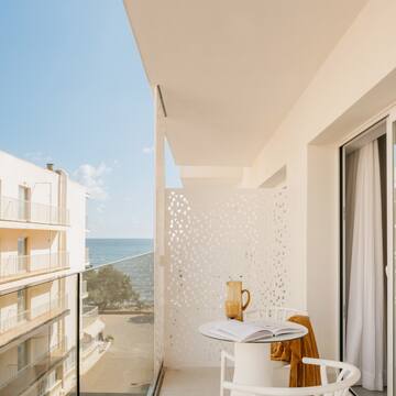 a balcony with a table and chairs